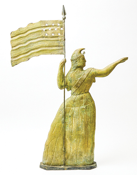 The large full-bodied molded and sheet-copper weathervane in the form of Lady Liberty holding a ten-star flag and raising her right arm was made by Cushing & White (formerly A.L. Jewell), Waltham, Massachusetts. The substantial figure, 38¾