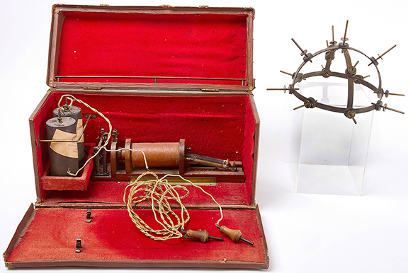 The German-made antique electric helmet in the original carrying case was likely used for therapeutic reasons. Its batteries are labeled “Alfred Gantz.” The case measures 10½