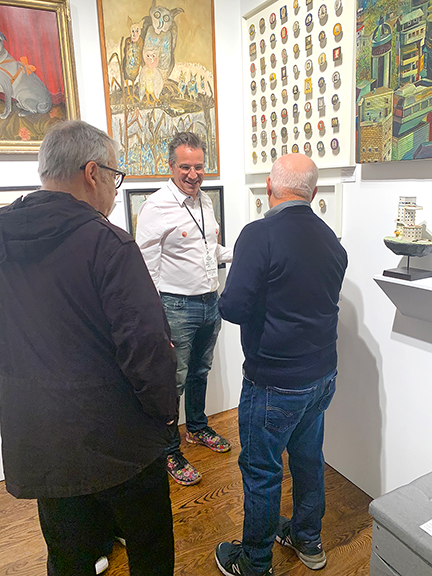 Steve Powers interacts with visitors in his booth.