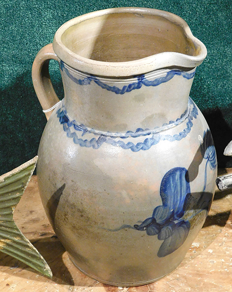 A robustly decorated mid-Atlantic two-gallon stoneware pitcher with cobalt swags, flowers, and foliage, standing 13