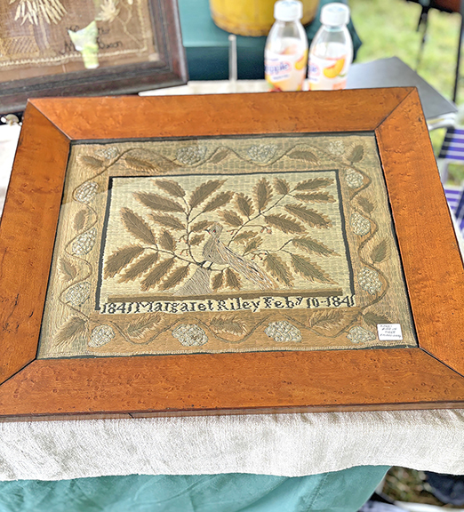 Lucinda Seward of Pittsford, Vermont, along with her husband, Michael, offered this satin-stitch sampler depicting a bird in a tree. It bears the name “Margaret Riley,” is dated “1841,” and was priced at $2250.