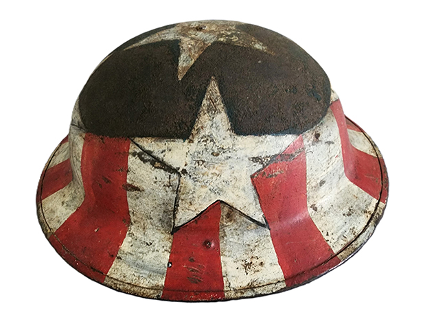 This is a very fine example of American folk art. A World War I helmet painted in red, white, and blue, with hand-painted stars. It has the original leather headrest on the inside. Dates to c. 1900. In very good condition with no repairs. 12¼