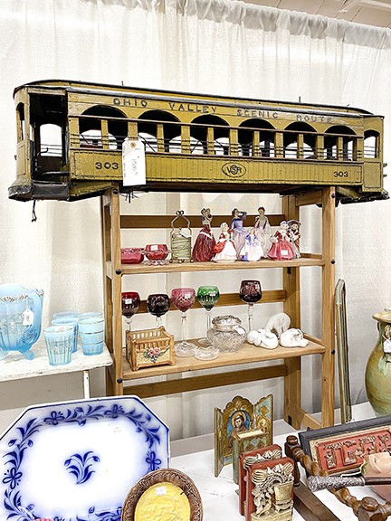 John Wanat of Indianapolis, Indiana, brought the circa 1910 folk-art tin trolley car priced at $1500 and the blue-and-white platter at bottom left priced at $300.