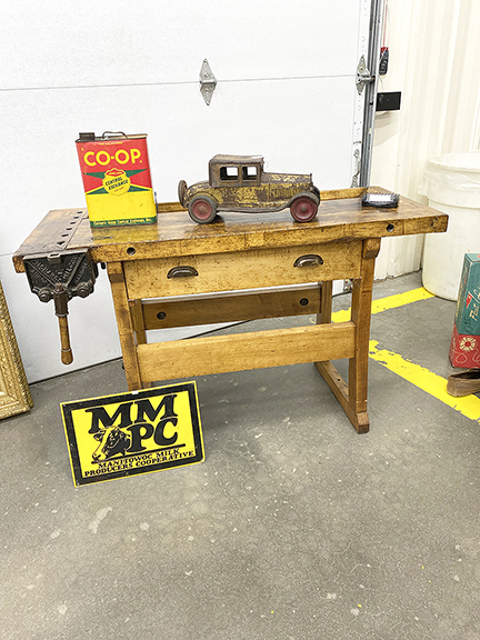 Offered by Second Chance Antiques, Crandon, Wisconsin, the late 1800s workbench was $1150, and the Co-Op gas can was $25. The 1920s tin car was $550, and the sign on the floor was tagged $155.