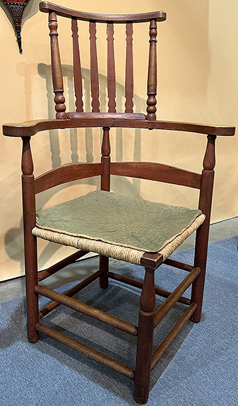 Patricia Clegg Antiques, East Berlin, Pennsylvania, offered this rush-seat Windsor corner chair, with a turned fluted crest, likely made in the Rhode Island and Connecticut border region, circa 1790, for $6750. The chair is made from maple, ash, and poplar. The seat has been replaced.